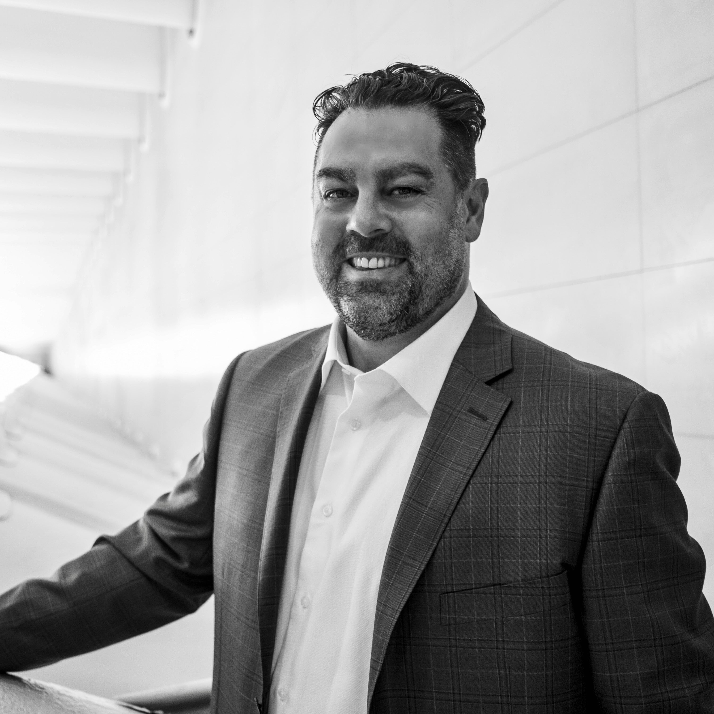 Nicholas, founder of Business Bible, smiling in a suit.
